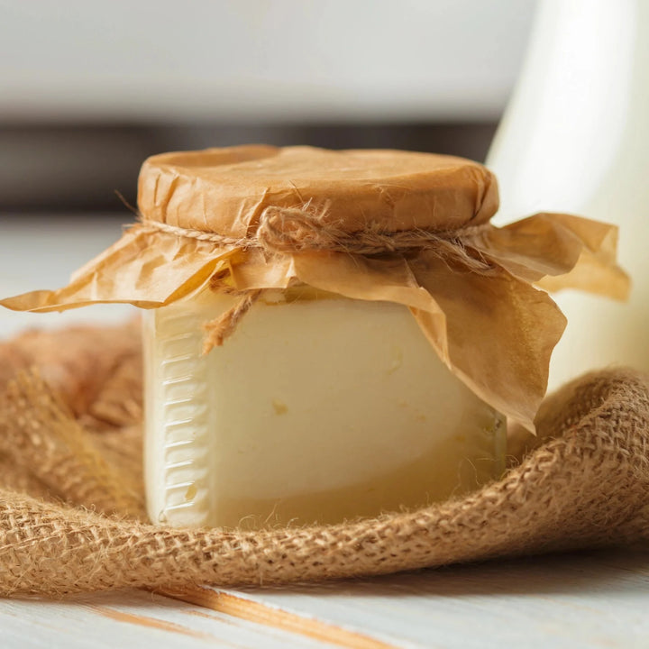 Jar of Lemmon cheese wrapped in burlap on a light surface